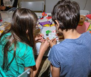 Two children work on an art project.