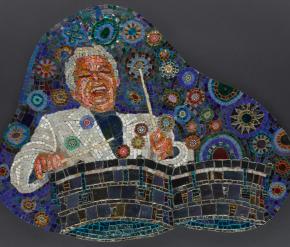 An image of a mosaic featured famed musician Tito Puente with an exuberant smile joyfully playing drums with a blue background filled with multicolored circles.