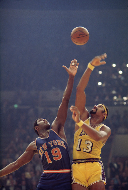 Willis Reed and Wilt Chamberlain tip off at the start of a basketball game