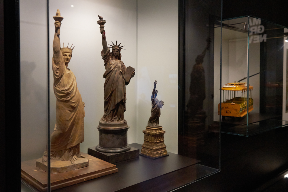 Mock-ups and models of the Statue of Liberty on display in an exhibition
