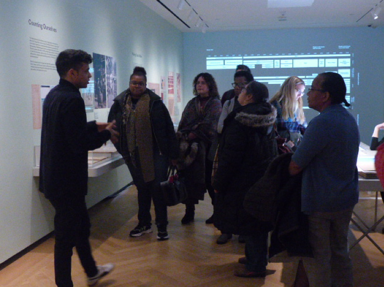 A group of teachers explore the Museum exhibition "Who We Are: Visualizing NYC by the Numbers"