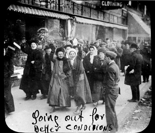 Women garment workers smile for the camera as they go on strike in 1909.