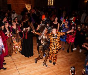  A lively crowd in colorful costumes enjoys dancing and celebrating at a Halloween party