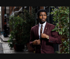 Image of Performer, The Odds dressed in burgundy suite near plants outdoors