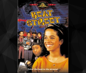  The Beat Street movie poster shows the title in bold, yellow graffiti-style text at the top. A smiling young woman is in the foreground, with other characters and a graffiti-filled background behind her. The tagline reads, "Takin' the beat to the streets!"