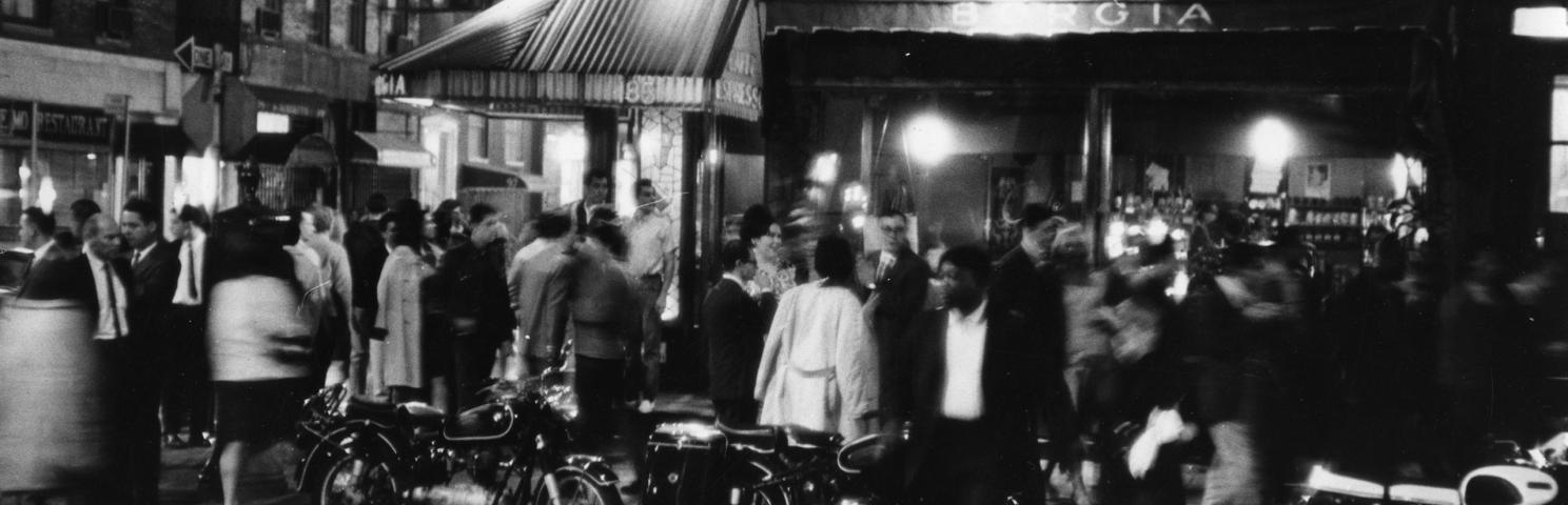 Photograph by Fred W. McDarrah of a motion-filled crowd outside the Caffe Borgia in Greenwich Village