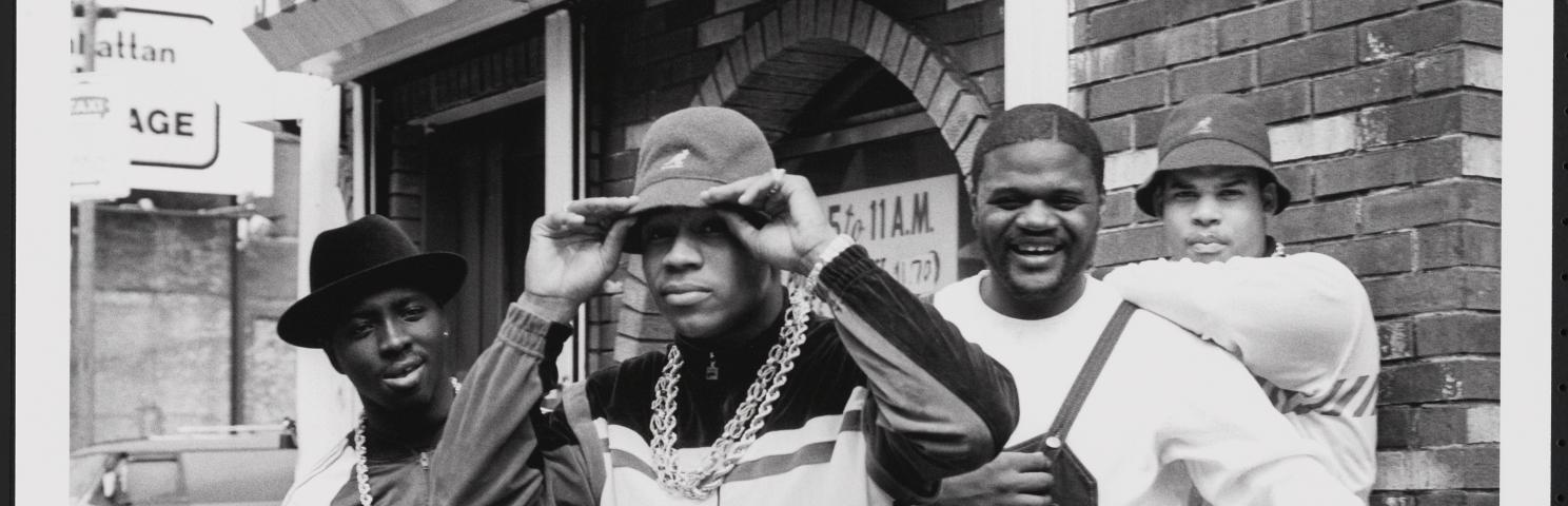 An Image of Image: a black and white image of LL Cool J with Cut Creator, E-Love, and B-Rock