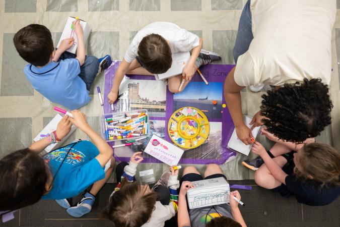 A group of students participating in an art making activity. 