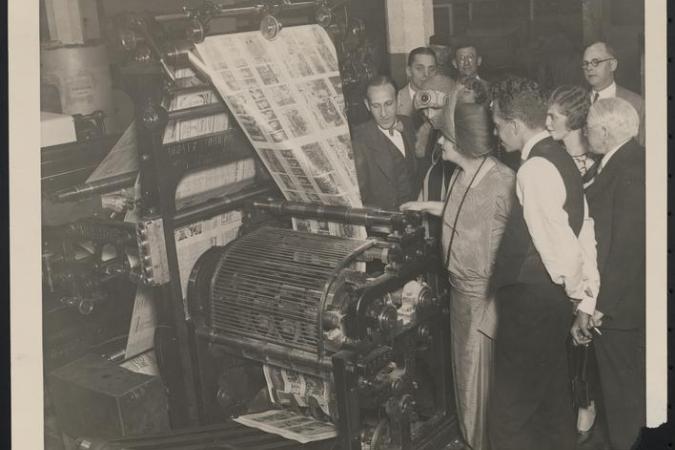 Sophie Tucker observing a paper press