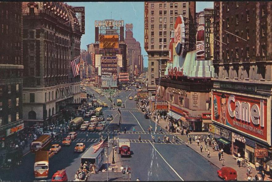 Wide view looking down the street of Times Square. 