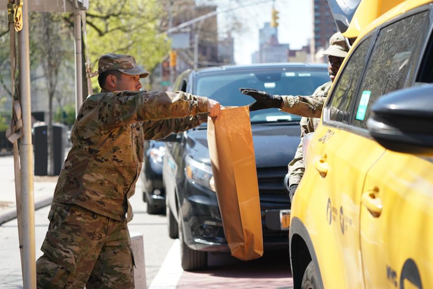 [Members of the U.S. Army National Guard distribute food in Harlem]