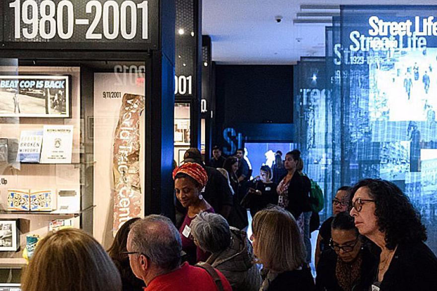 Educators listening to a tour in the New York at Its Core exhibition at the Museum of the City of New York.