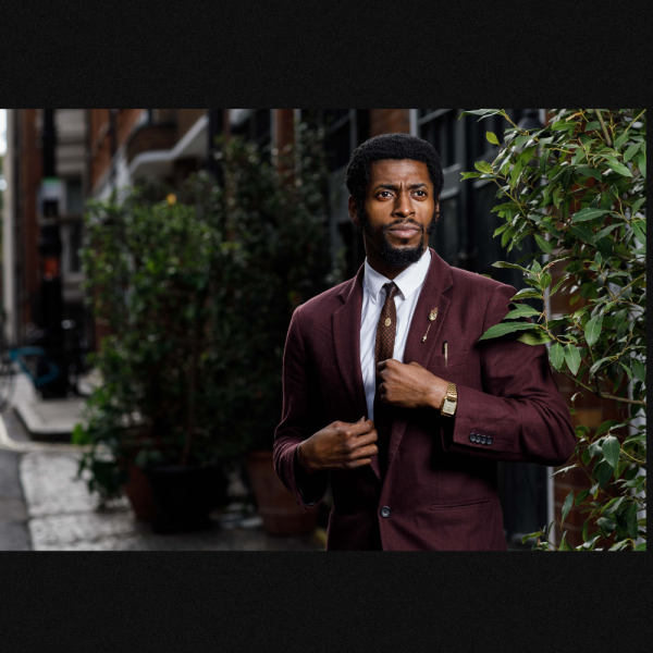 Image of Performer, The Odds dressed in burgundy suite near plants outdoors