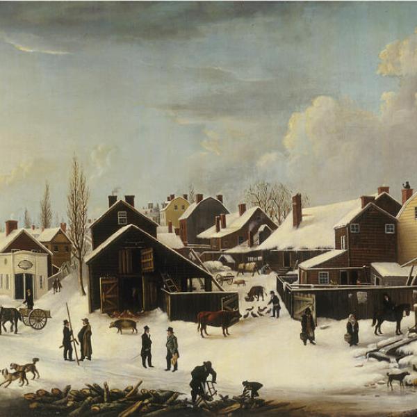 A wintery scene with snow on the ground, people in the foreground and multicolored homes