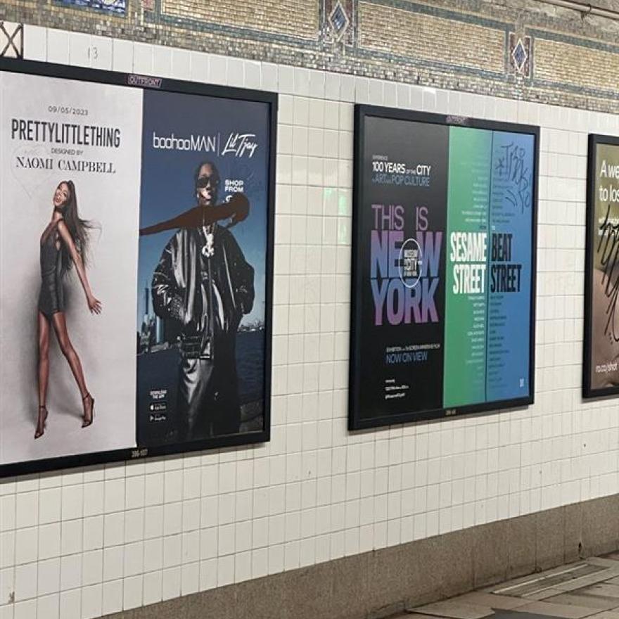 Subway card ad for the exhibition "This Is New York" on the platform at 96th street.