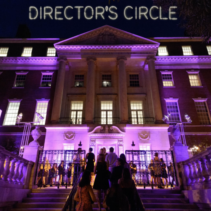 Entrance to a museum lit with purple light for a party.