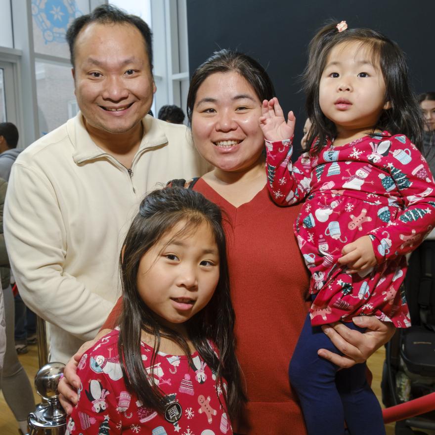 A family smiles for the camera.