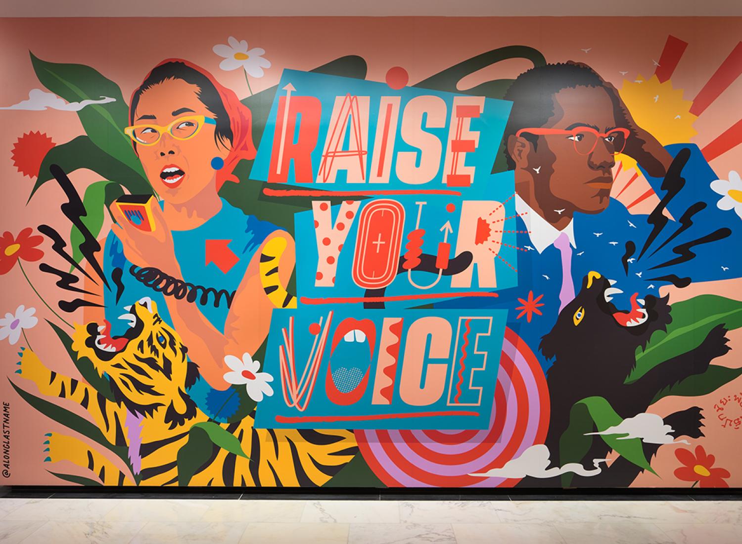 Photograph of the immersive installation "Raise Your Voice," original artwork of activists and allies Yuri Kochiyama and Malcolm X by artist Amanda Phingbodhipakkiya.