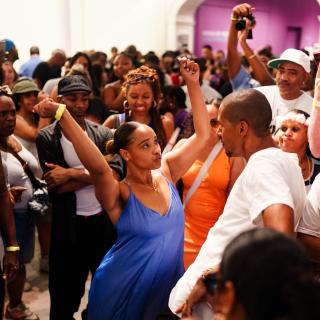 Woman and man dancing in a crowd of people