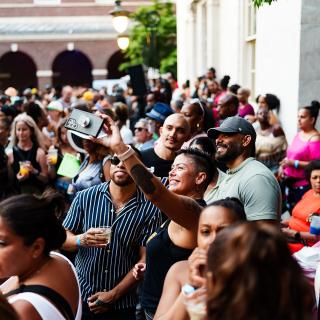 A group of people taking a photo, standing in a crowd at the Museum