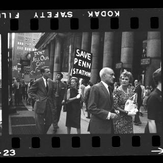 A group of marchers hold signs protesting the demolition and renovation of Penn Station