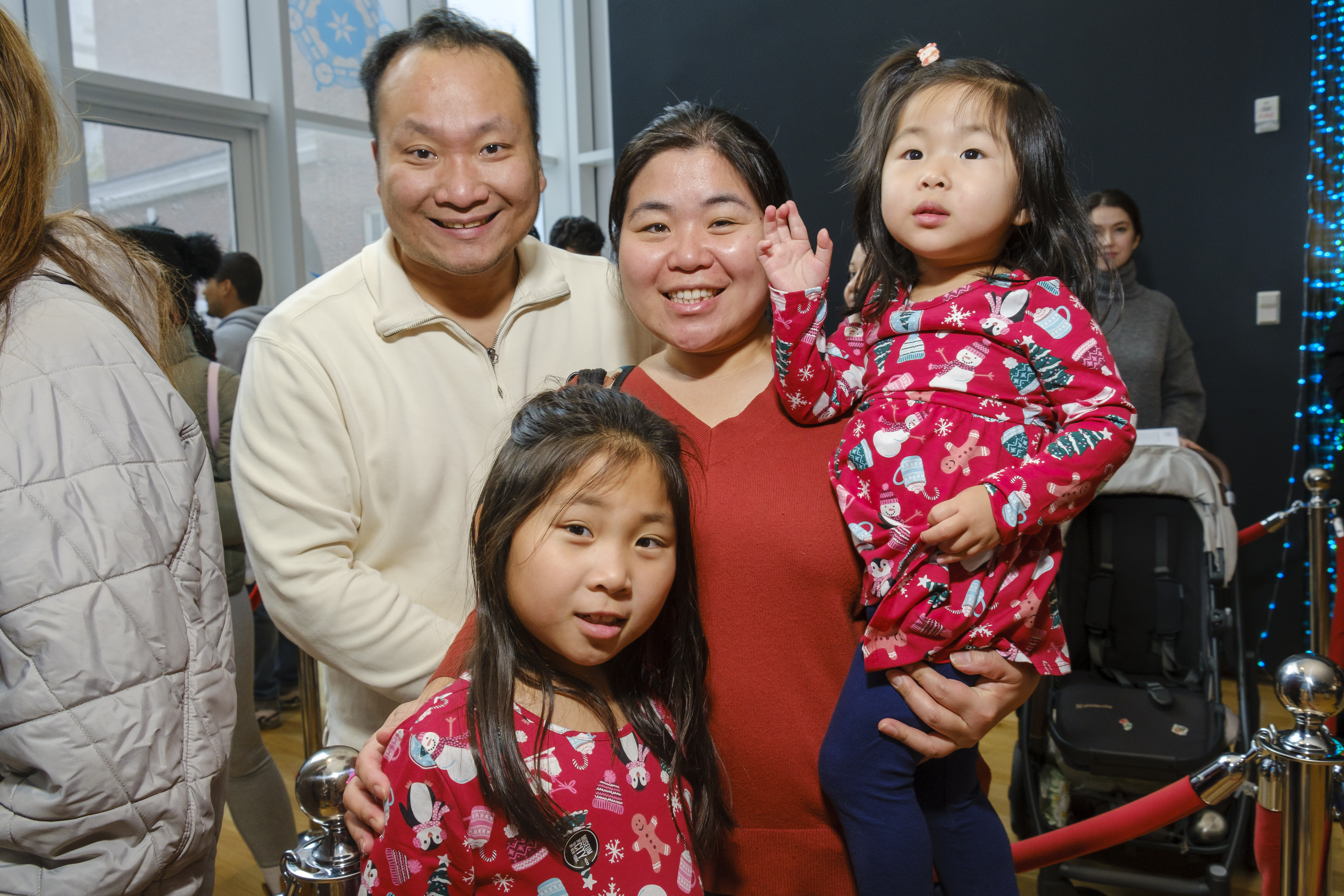 A family smiles for the camera.